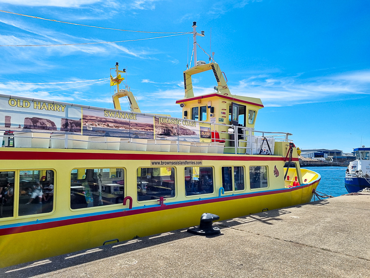 One of the small yellow ferry boats docked at Poole Harbour which take you on the short crossing for a day out on Brownsea Island in Dorset