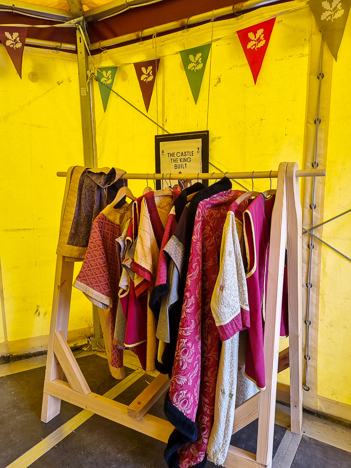 Rail of medieval style clothing in a tent as part of some of the summer fun at Corfe Castle for kids