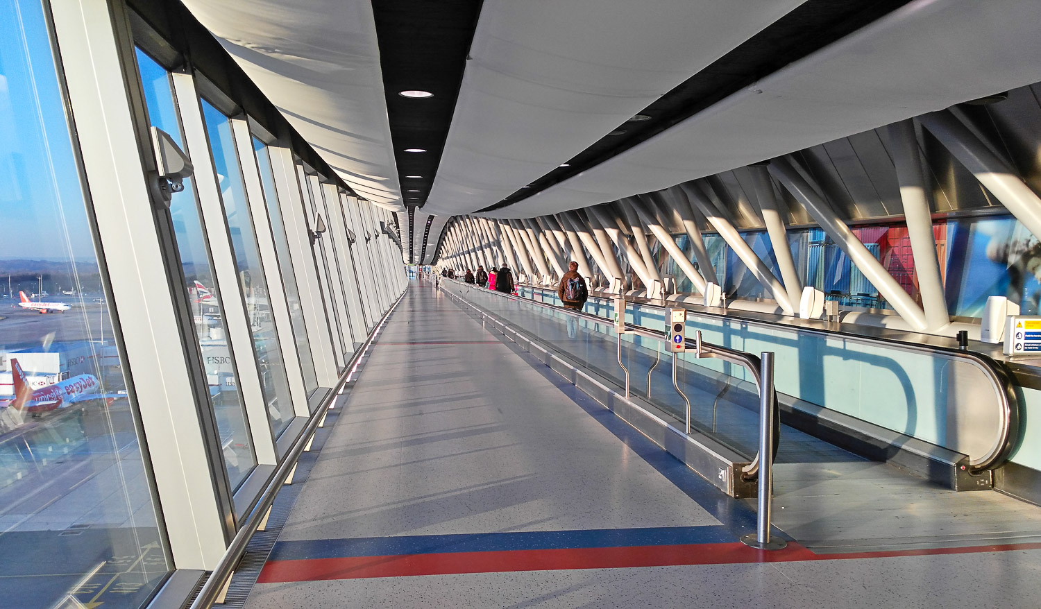Moving walkway at Gatwick airport with planes visible through the windows - my tips on the best way to get from Gatwick to central London