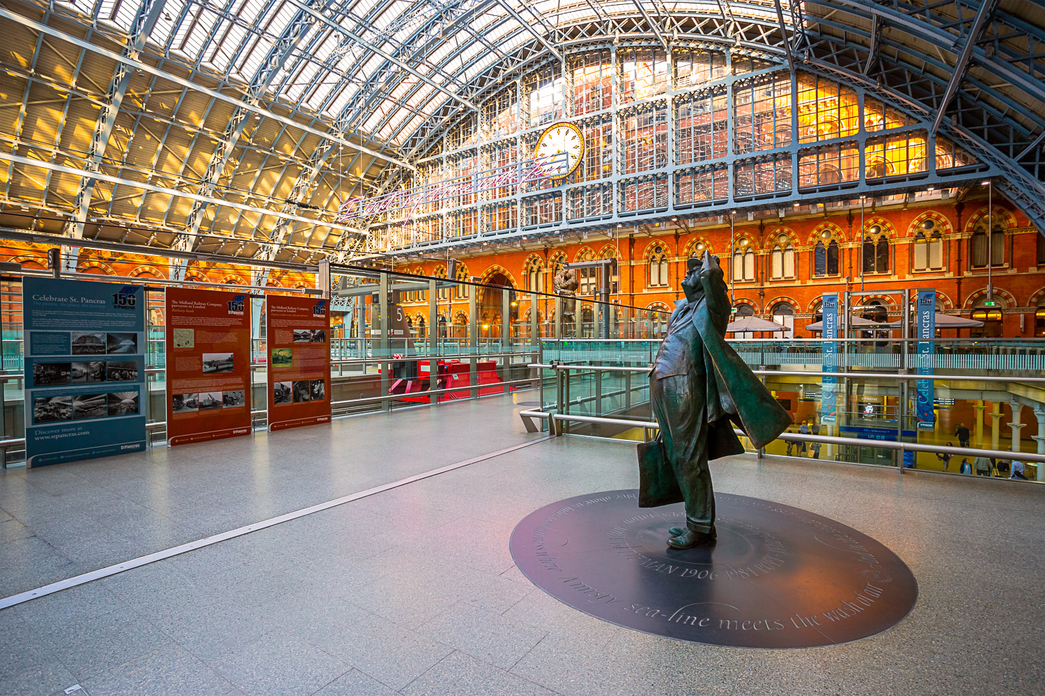 Interior of St Pancras International station with the statue of Sir John Betjeman - the station is one of the stops if you're taking a train from Luton airport to central London