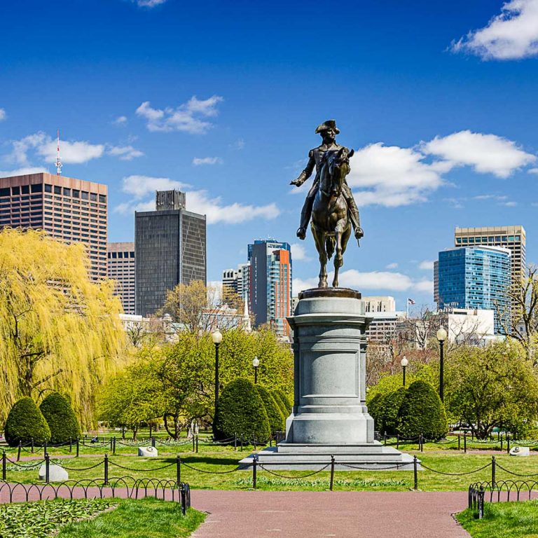 Statue in the Public Garden in Boston, Massachusetts, with skyscapers in the background - the best things to do in Boston with kids on a US family city break
