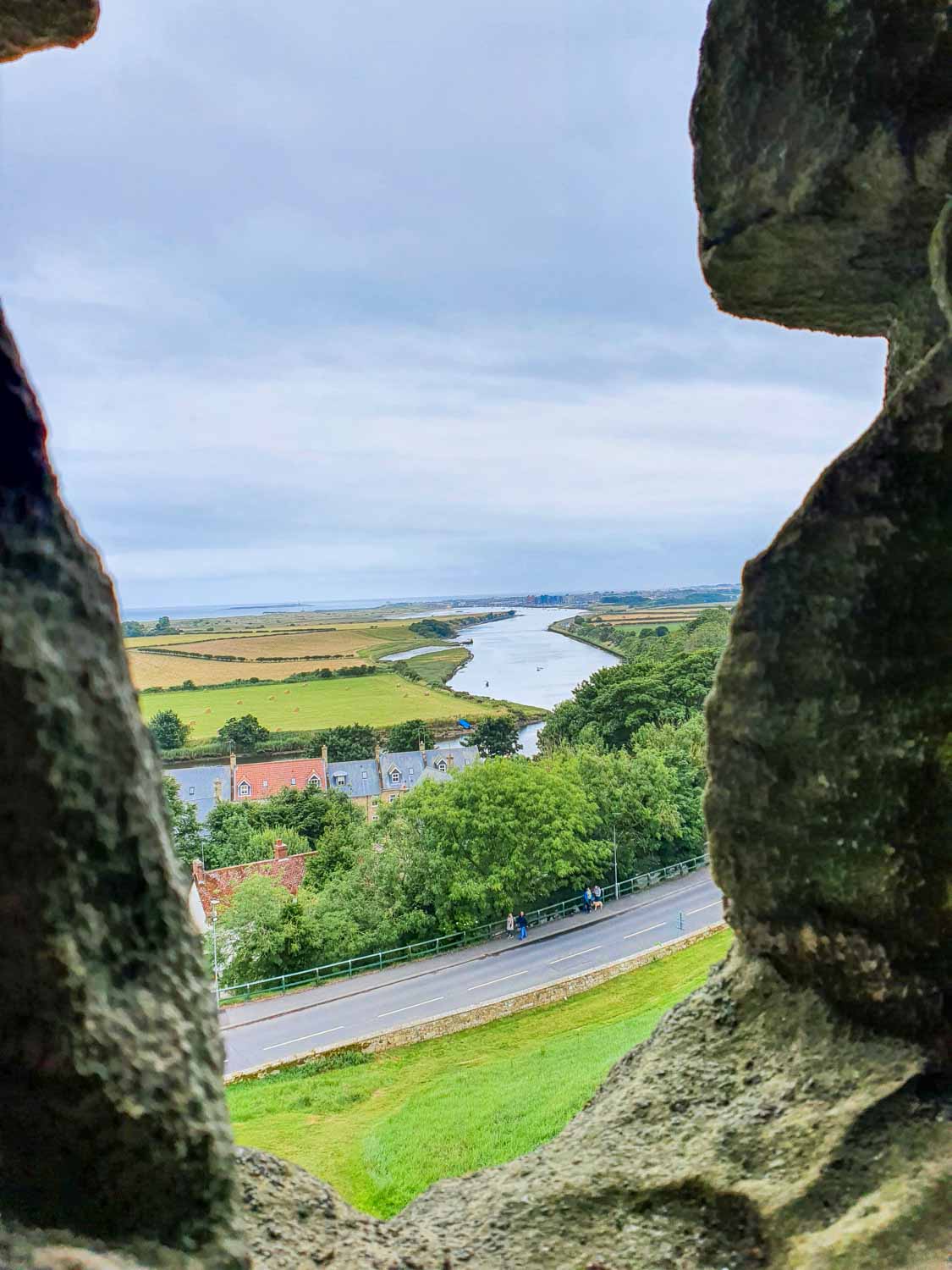 View out along the river Coquet and the fields from one of the windows of Warkworth Castle, Northumberland