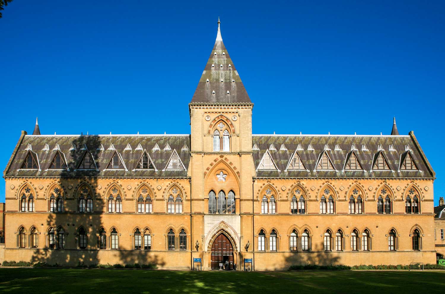 Gothic exterior of the building housing the Natural History Museum at Oxford University and the Pitt Rivers Museum against a blue sky - my day trip to the Pitt Rivers Museum with a baby