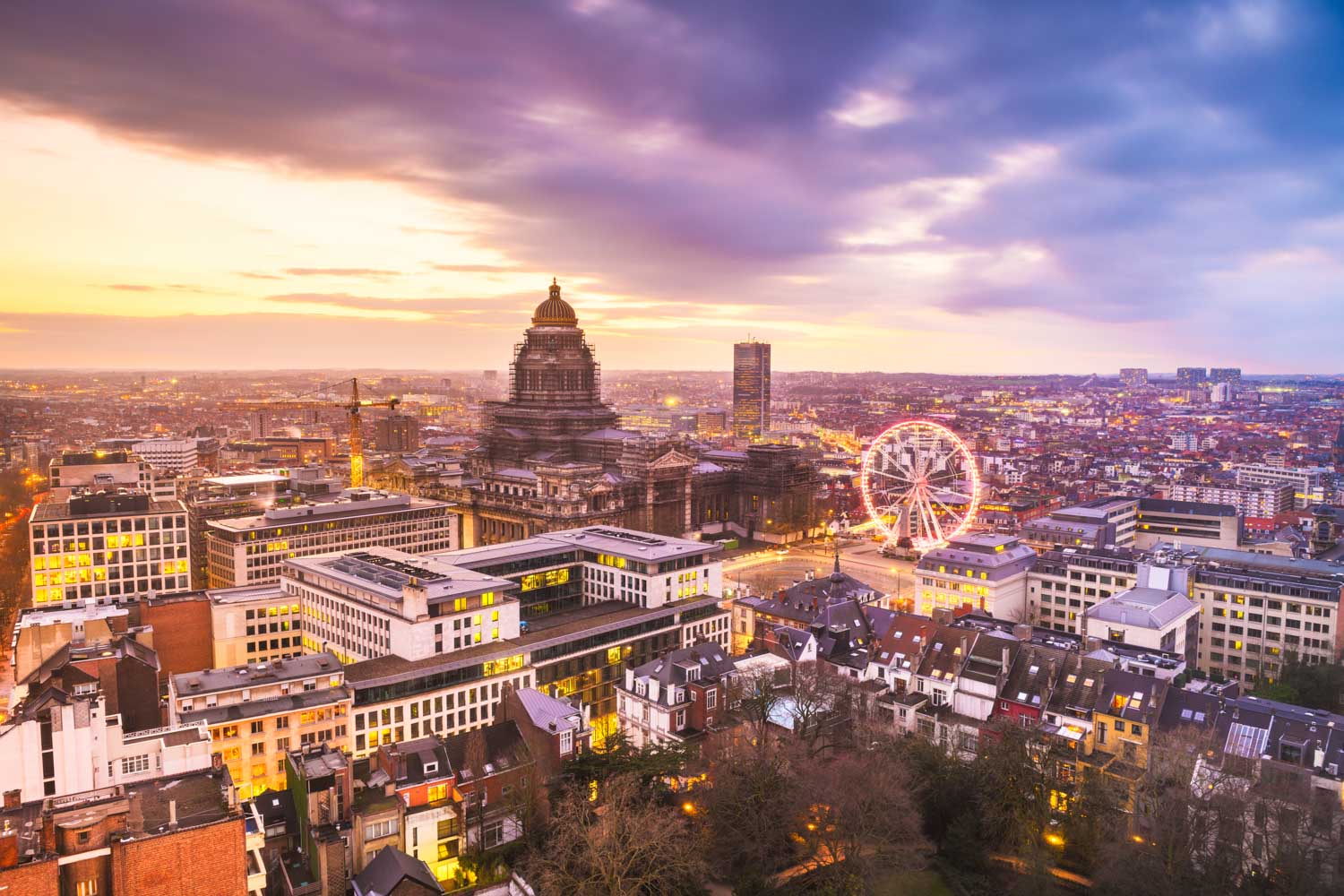 Aerial view of the cityscape of Brussels at dusk including illuminated ferries wheel and Palais de Justice - my tips on visiting Belgium with kids