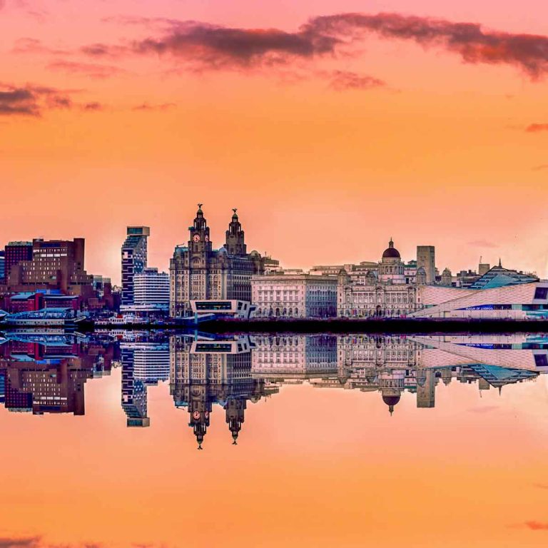 Liverpool skyline at sunset with a panoramic view of all the famous landmarks reflected in the river Mersey - my top things to do in Liverpool with kids