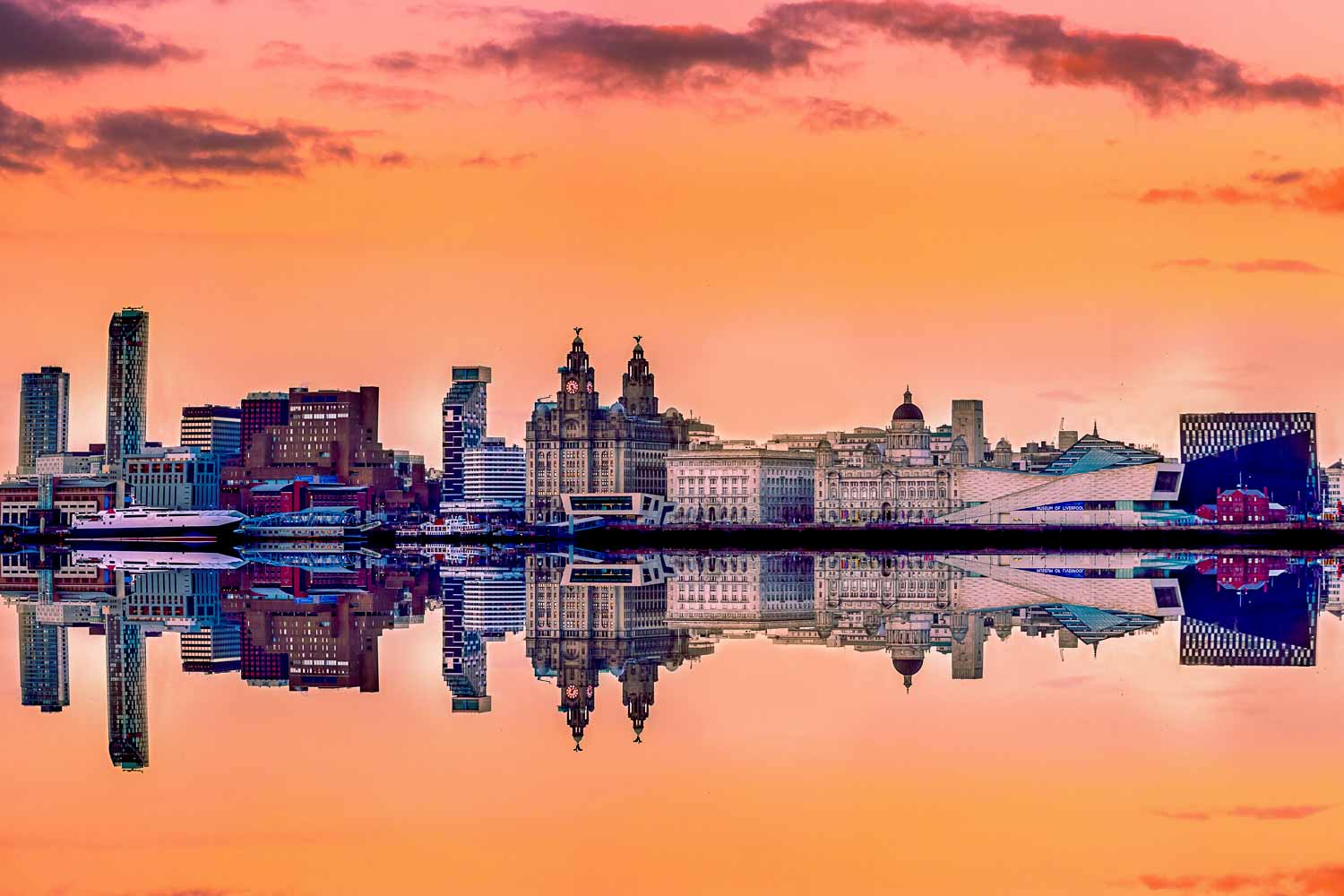 Liverpool skyline at sunset with a panoramic view of all the famous landmarks reflected in the river Mersey - my top things to do in Liverpool with kids