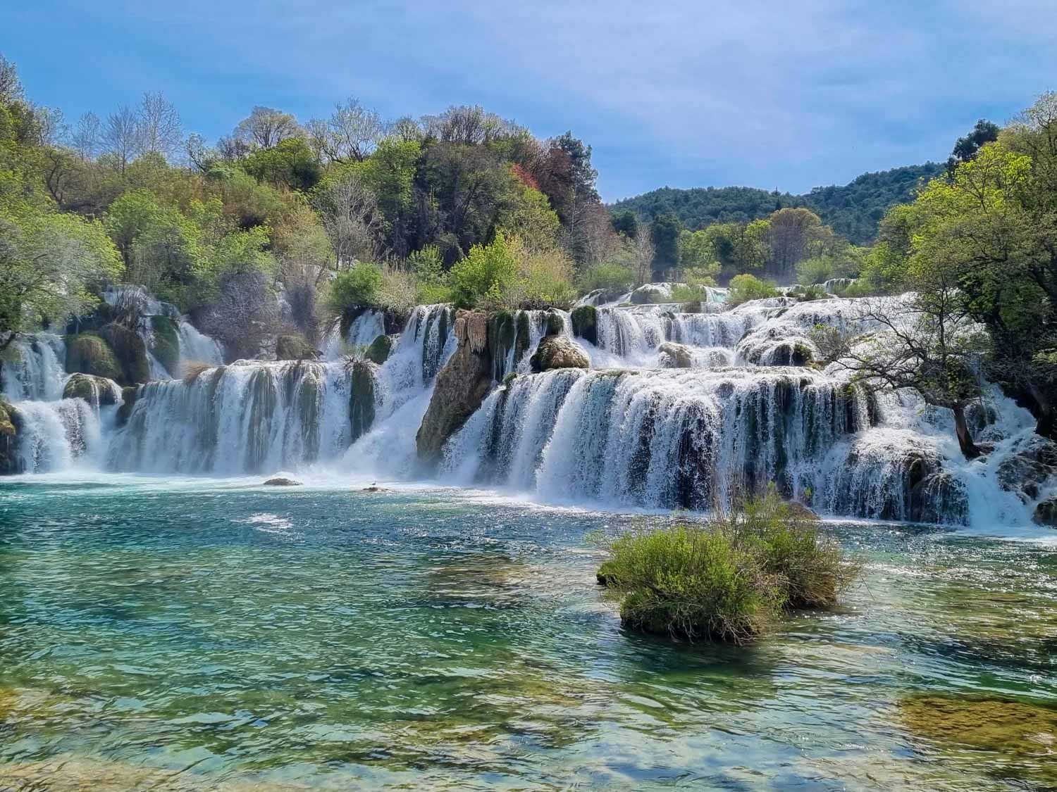 View of the turquoise water by one of the best known waterfalls of Krka National Park - one of the best day trips from Split with kids