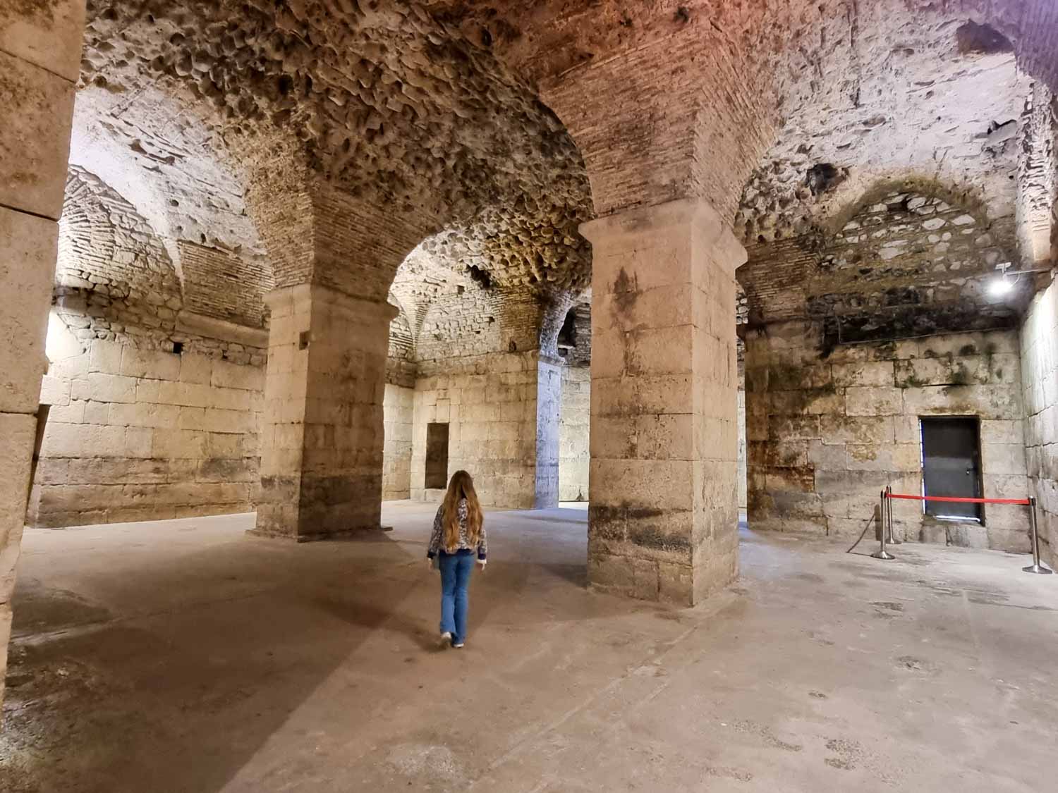 My daughter walks through the vaults of Diocletian's Palace in Split - exploring the ancient Roman remains is one of the best things to do in Split with kids