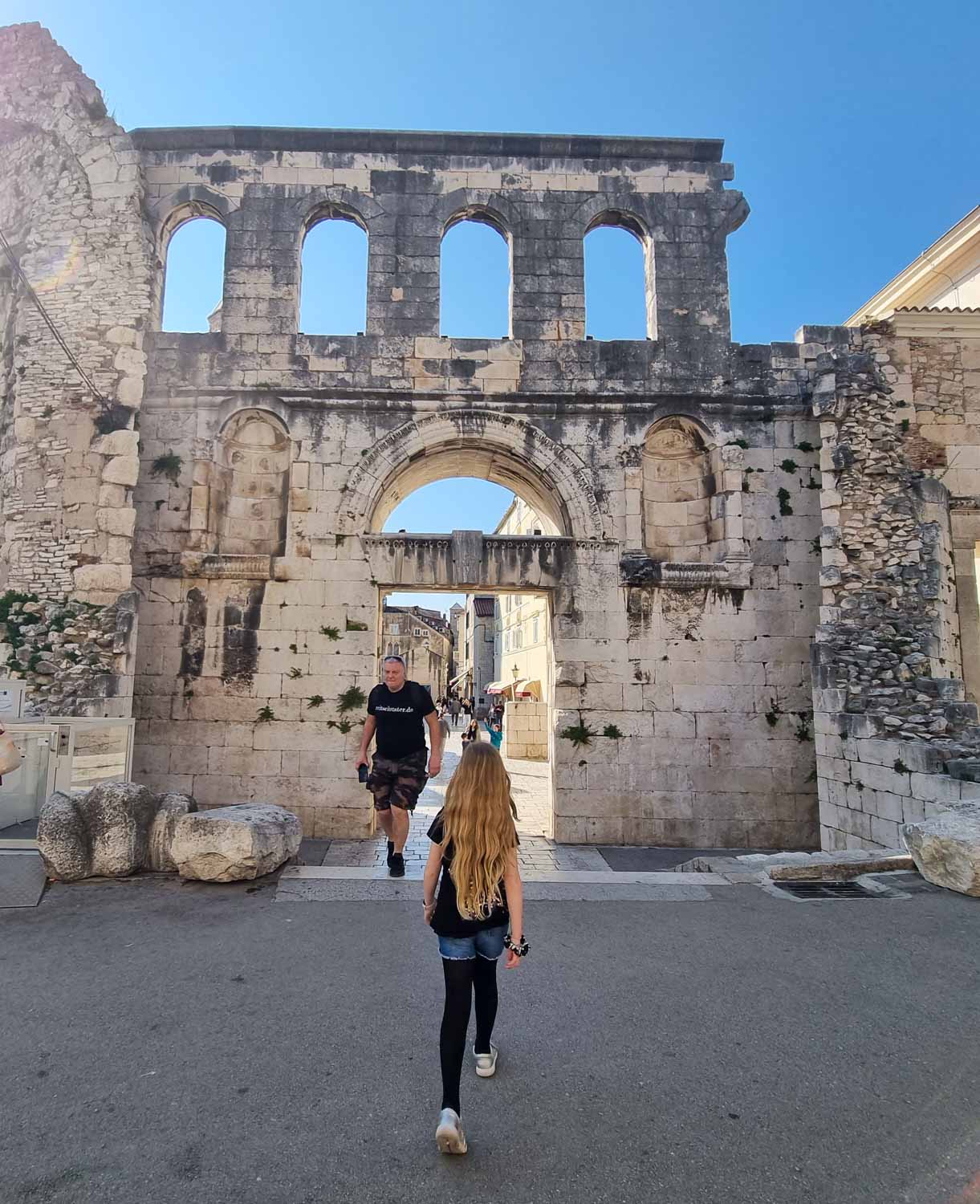 My daughter walks towards the Silver East Gate of Split - exploring the old streets of Diocletian's Palace is one of the best things to do with kids in Split
