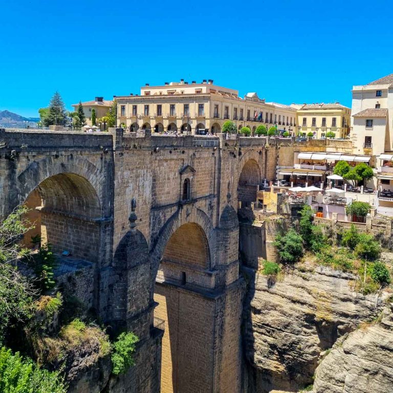 View across the Puente Nuevo bridge to the houses and buildings on the other side of the gorge - the symbol of the town, viewing the bridge is one of the unmissable things to do in Ronda with kids
