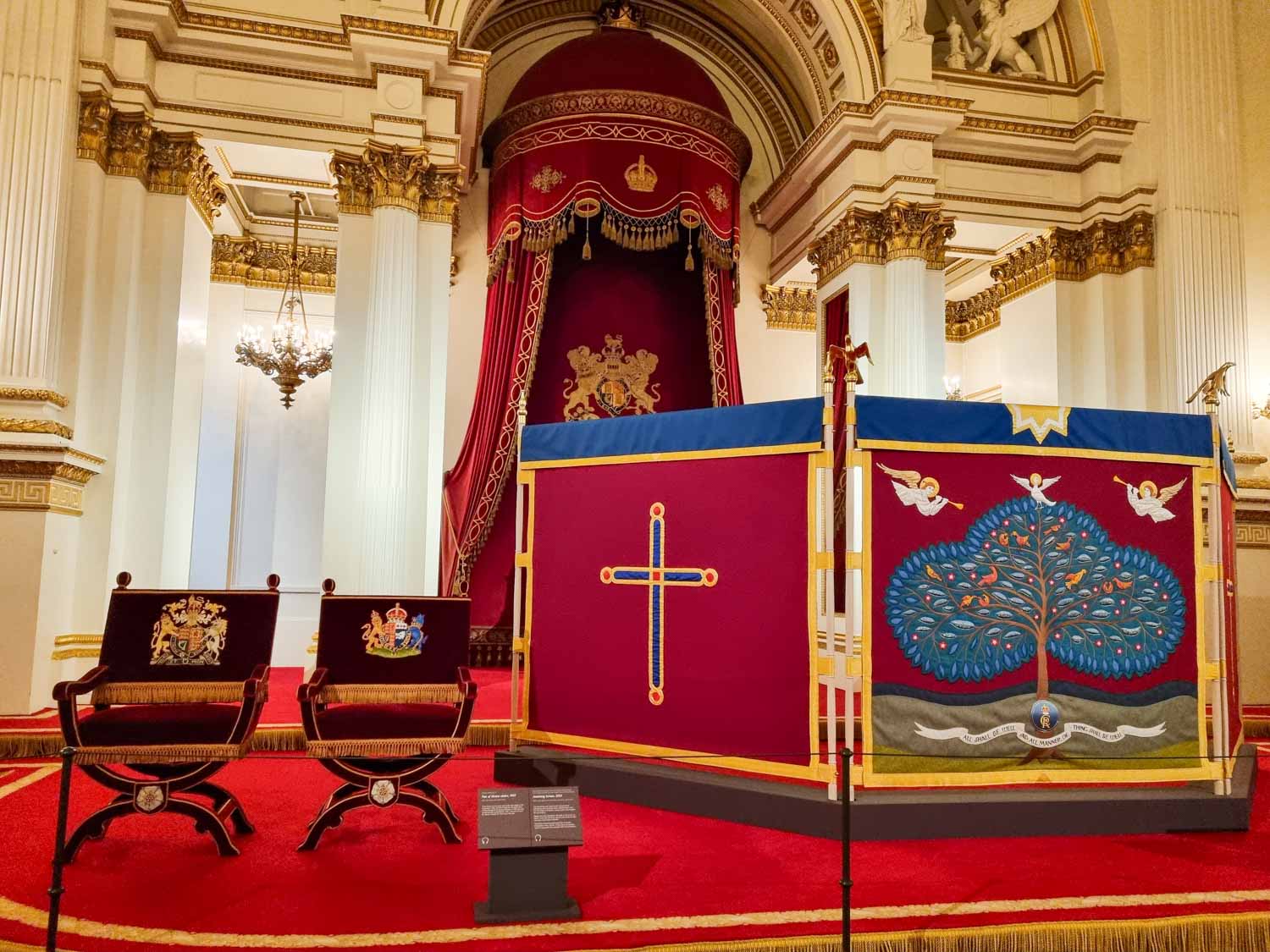 View of the Anointing Screen and throne chairs used during the Coronation ceremony of King Charles III, on display as part of a special Coronation exhibition at Buckingham Palace - one of the reasons to visit Buckingham Palace with kids in 2023