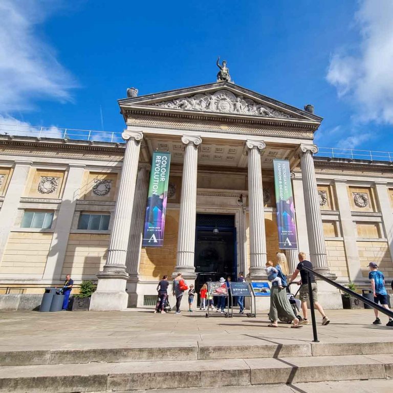 Exterior of the Ashmolean Museum in Oxford on a sunny day with families walking towards the entrance - my review and tips for visiting the Ashmolean Museum with kids