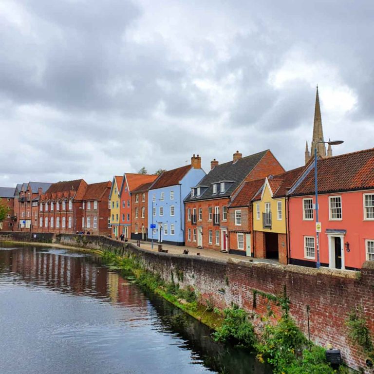 View of the colourful houses on the quayside in Norwich on a cloudy day - my tips of the best things to do in Norfolk in the rain with kids