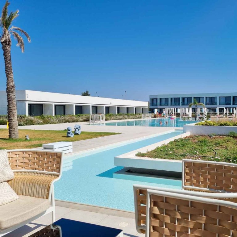 View across water feature to one of the pools and the white cubed buildings at Gennadi Grand Resort in Rhodes - my Gennadi Grand Resort review