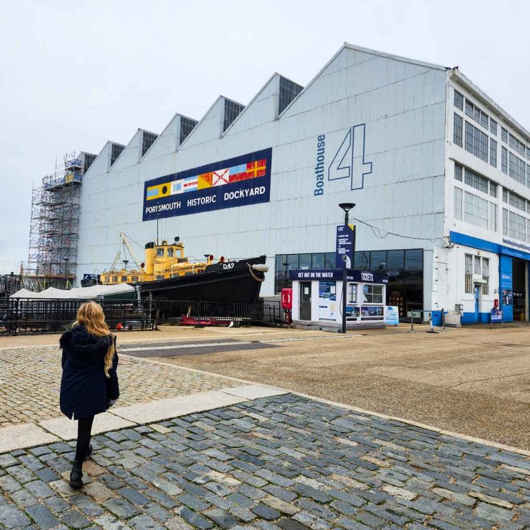 My daughter walks towards Boathouse 4 during a day out at Portsmouth Historic Dockyard with kids
