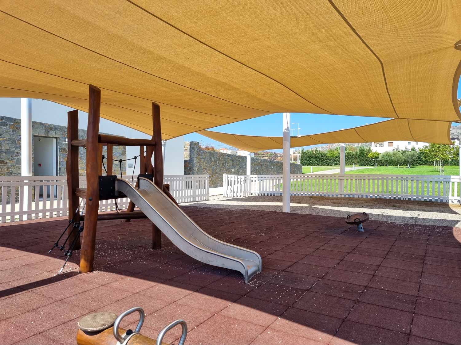 View of the small play area including a metal slide under the shade at Gennadi Grand Resort in Rhodes - my review