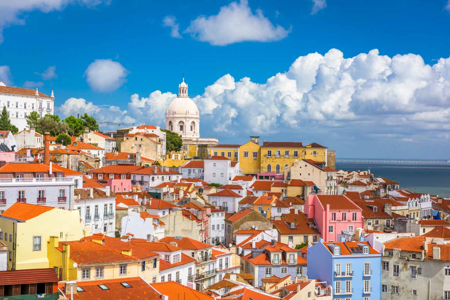 A view of the rooftops and brightly coloured buildings of the Alfama in Lisbon, Portugal - exploring the Moorish castle is one of my top things to do in Lisbon with kids