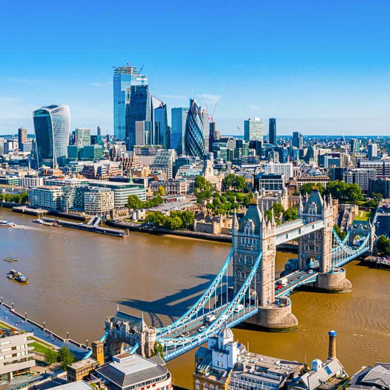 View across Tower Bridge and the Thames to the skyscrapers of the city of London on the skyline - the best views of London with kids, including free viewpoints and historic sites