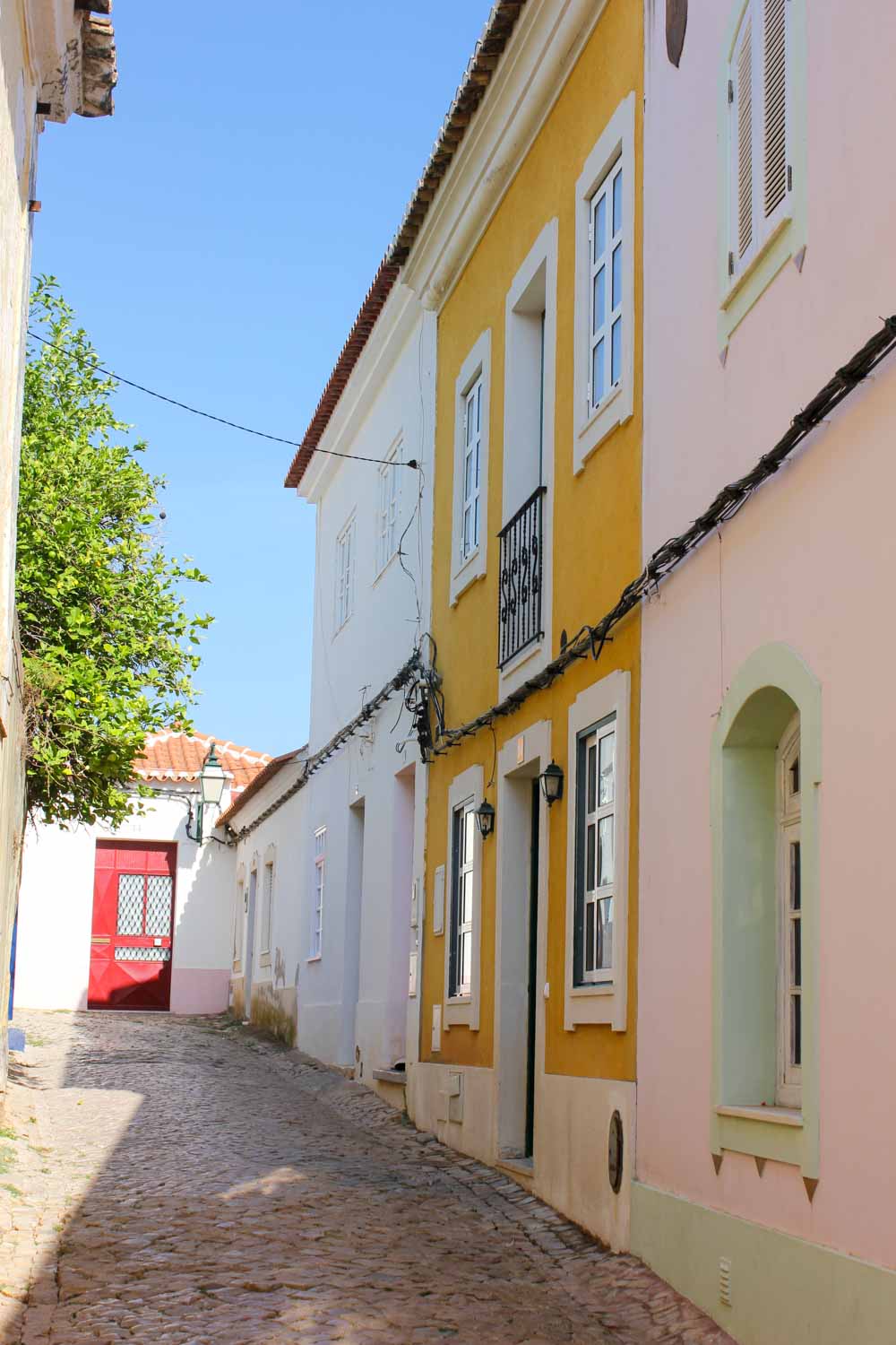 Cobbled streets of Silves with pastel coloured buildings - walk around the town after you visit Silves Castle with kids
