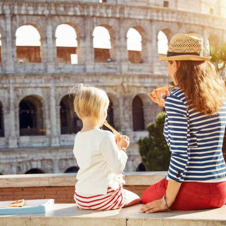 Mother and daughter sitting by the Colosseum in Rome - my city tripping tips for the best city breaks with kids