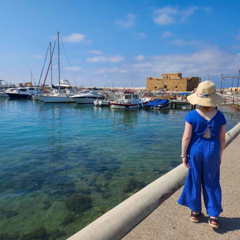 My daughter looks along the harbourfront towards Paphos Castle - my tips for the best things to do in Paphos with kids