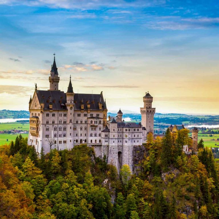 Neuschwanstein castle in Bavaria, Germany against a blue sky - one of many real life places that inspired Disney films