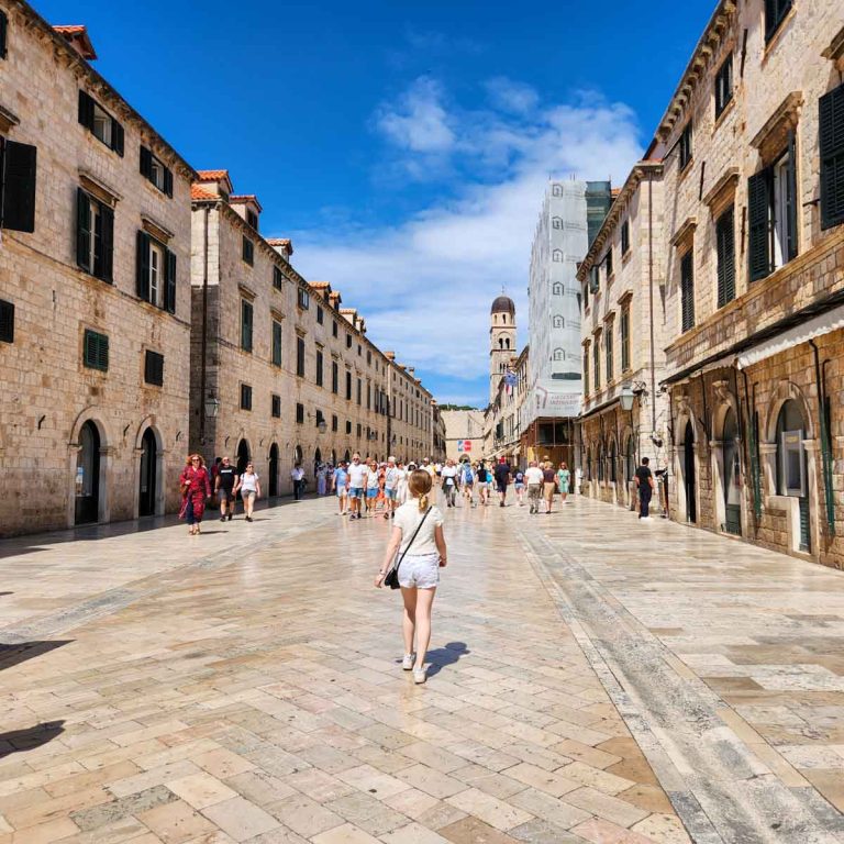 My daughter walks along the main pedestrian street Stradun in Dubrovnik's old town - my tips on the best things to do in Dubrovnik with kids