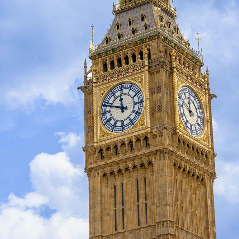 Clock face of the Elizabeth Tower housing Big Ben against a blue sky - my review of a Big Ben tour with kids
