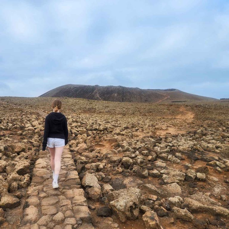 My daughter walks up the volcanic path towards Calderon Hondo, the easiest route if you're climbing climbing Calderon Hondo with kids