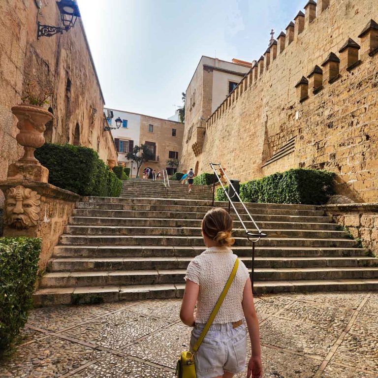 My daughter walks towards the steps up to the old town in Palma de Mallorca - my tips on the best things to do in Palma with kids
