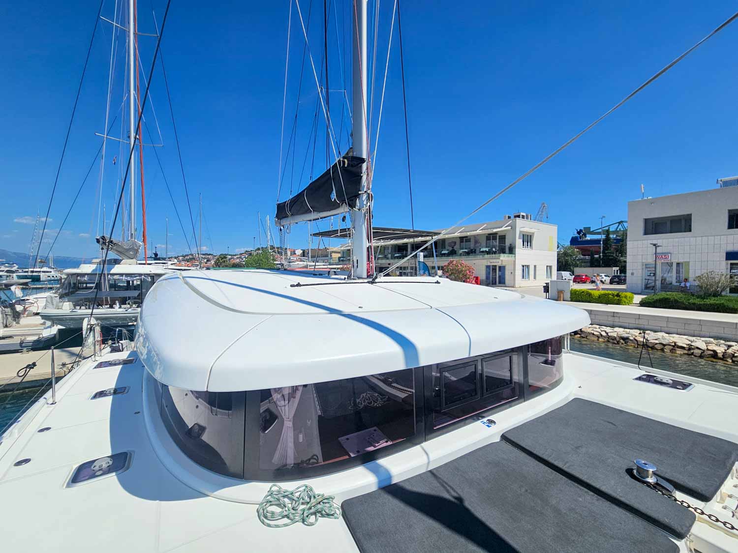 View across the cushions at the front of the boat to the roof and other boats moored beyond at Trogir marina - my More Sailing Croatia review