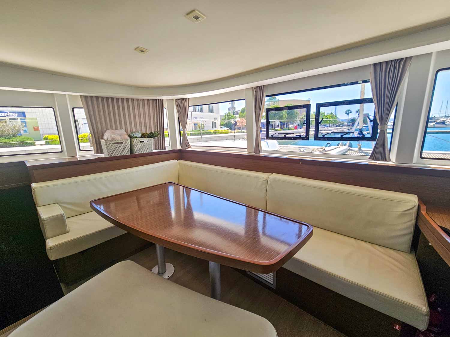 Indoor seating area with table on our Lagoon 42 catamaran - my review of a More Sailing Croatia holiday