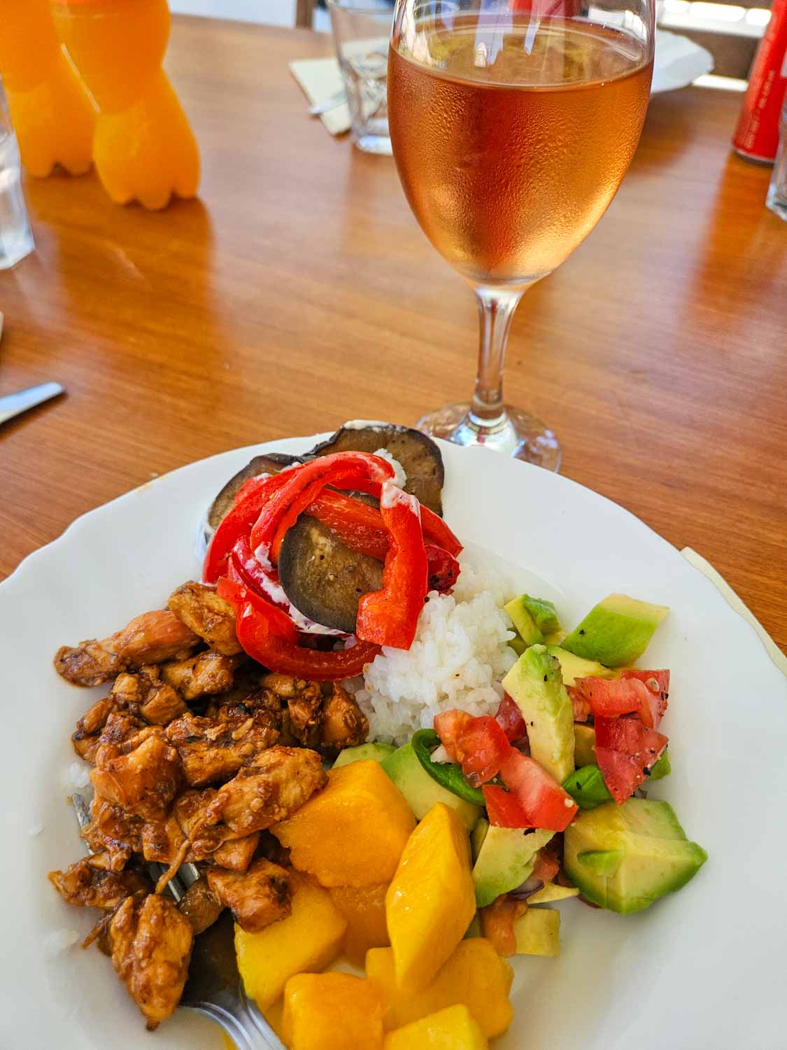 Lunch on board our More Sailing catamaran with chicken, mango, avocado, rice and salad plus a glass of rose - my review of a Croatia sailing holiday with kids