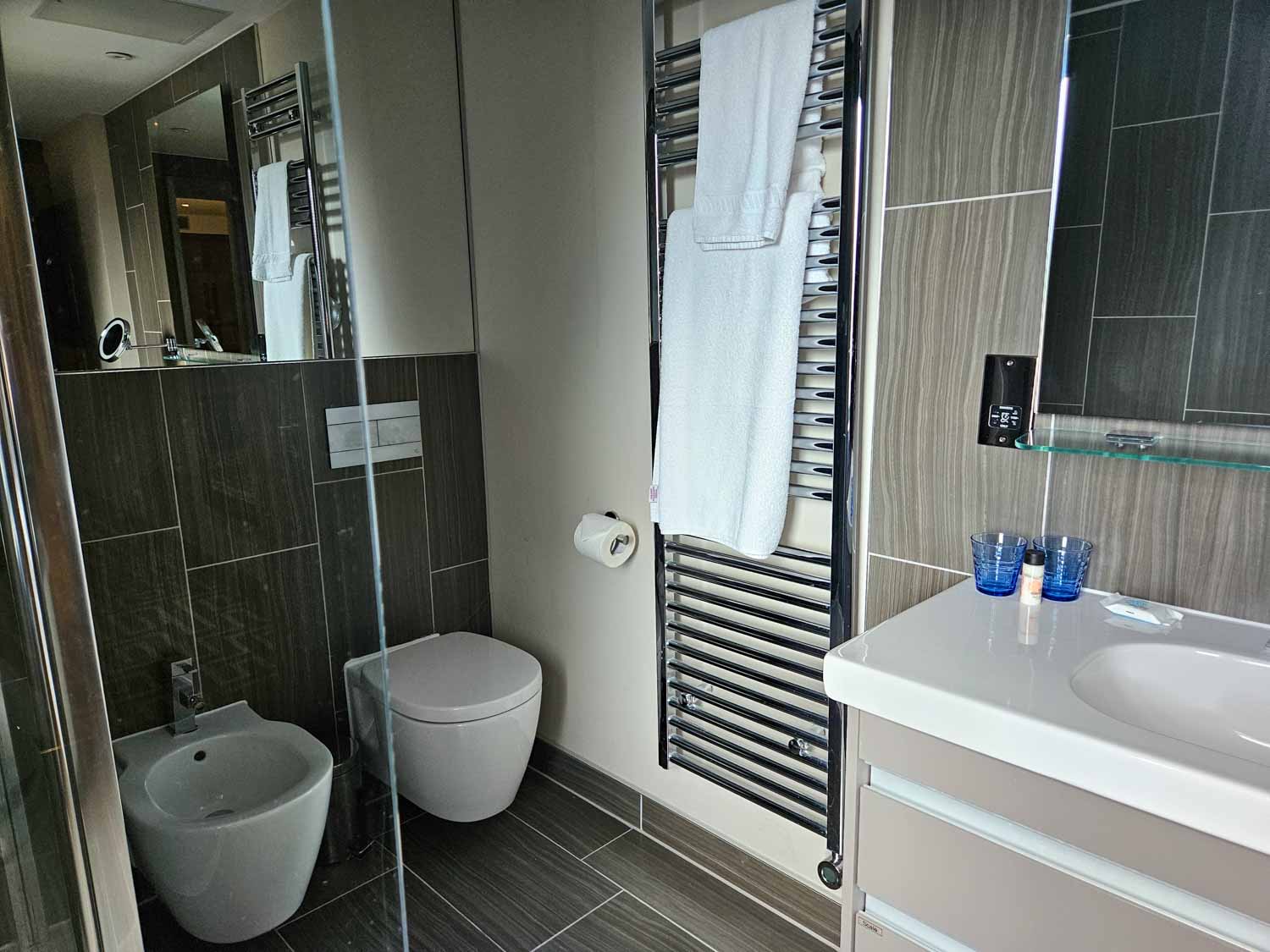 Sink, toilet, bidet and edge of the shower cubicle in our suite bathroom - my Courthouse Hotel Shoreditch review