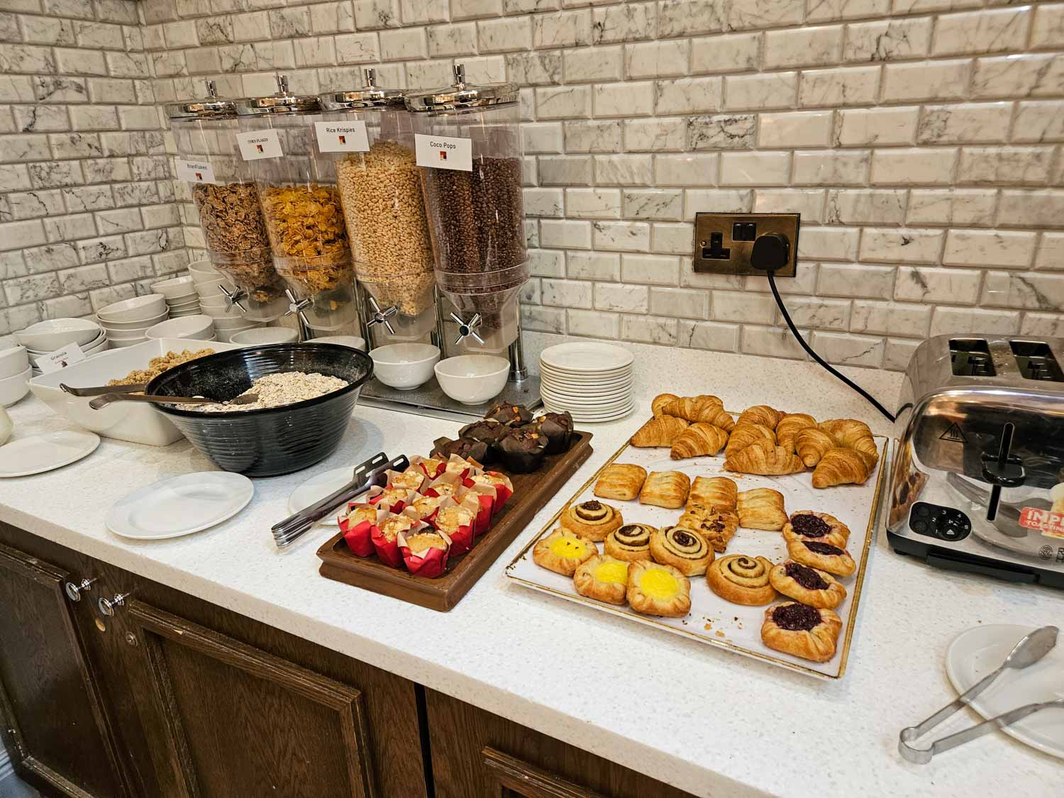 Pastries and cereal plus a toaster at breakfast in the Judge & Jury restaurant - my Courthouse Hotel Shoreditch review