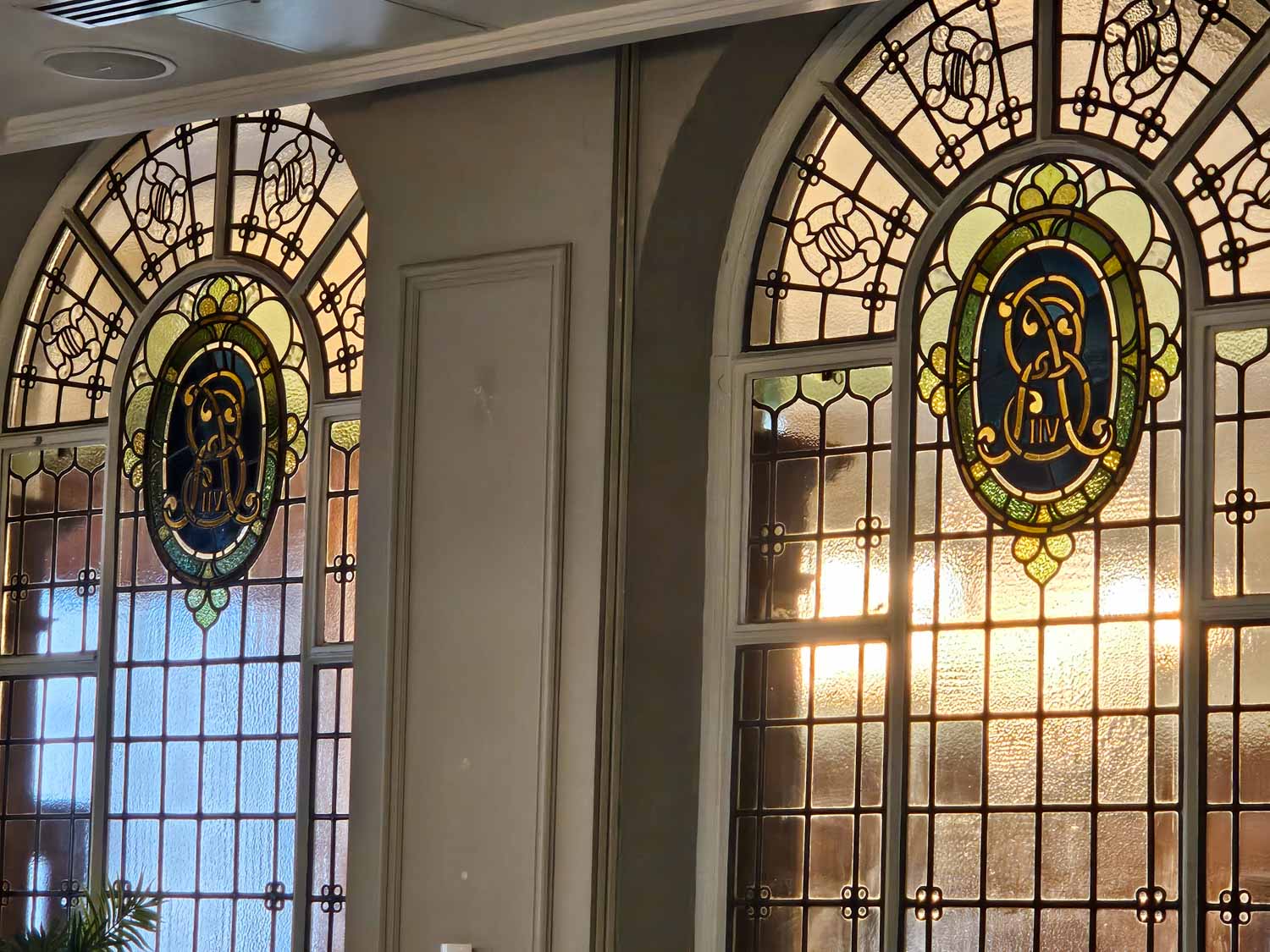 Stained glass showing the reverse of Edward VII's cipher, from the time when the building was the Old Street Magistrates court and police station - my Courthouse Hotel Shoreditch review