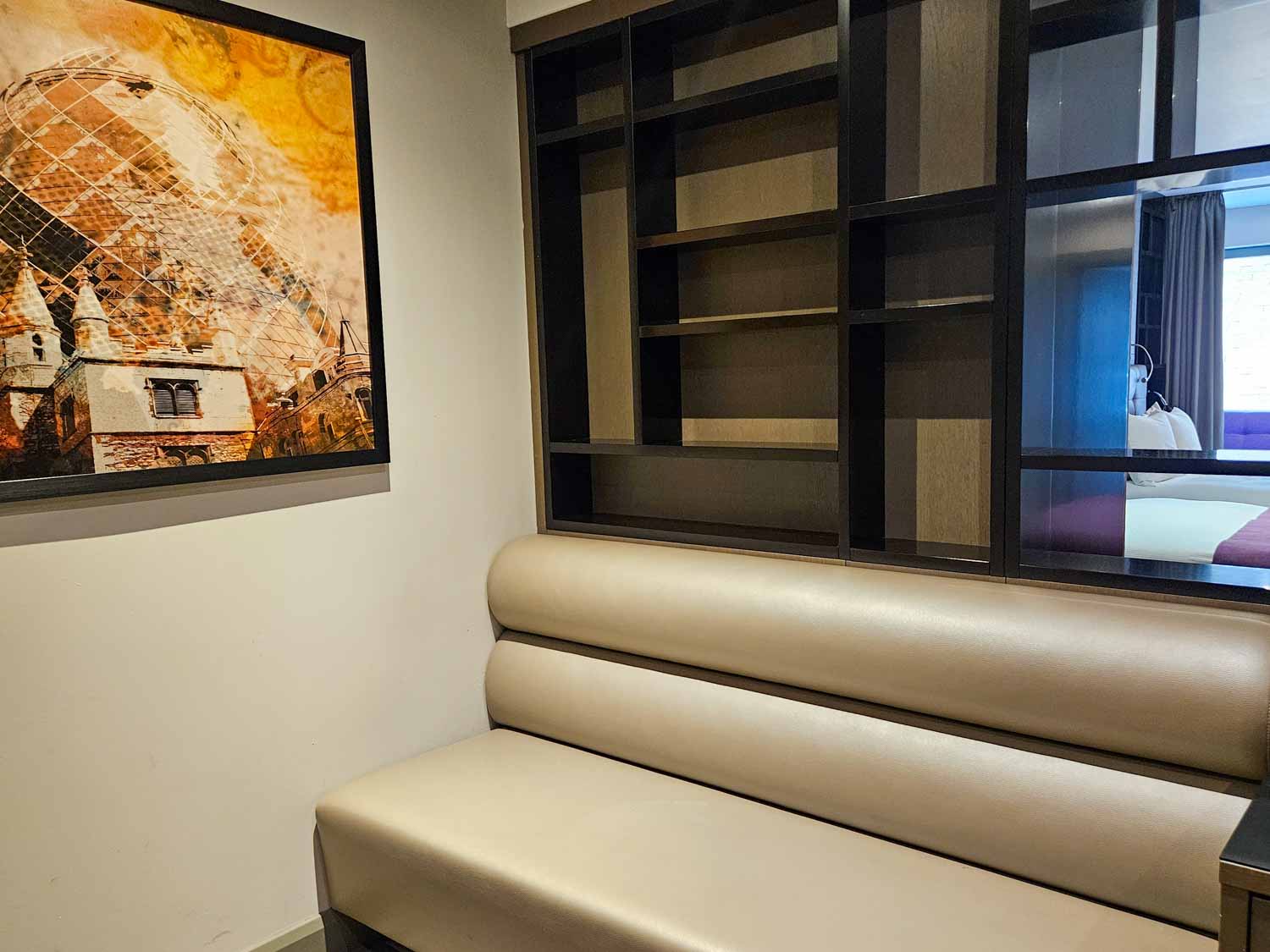 Leather effect bench seat in part of our Hoxton family suite, with artwork on the wall - my Courthouse Hotel Shoreditch review