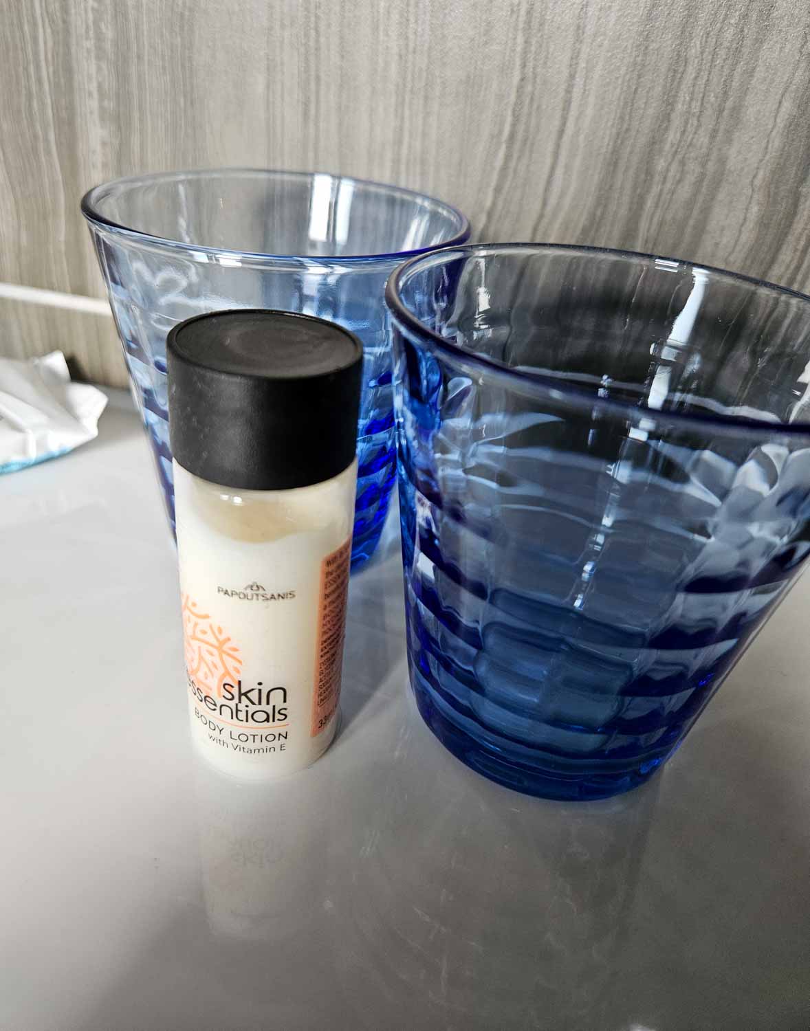 Blue glasses and Skin Esssentials toiletries in our suite bathroom - my Courthouse Hotel Shoreditch review
