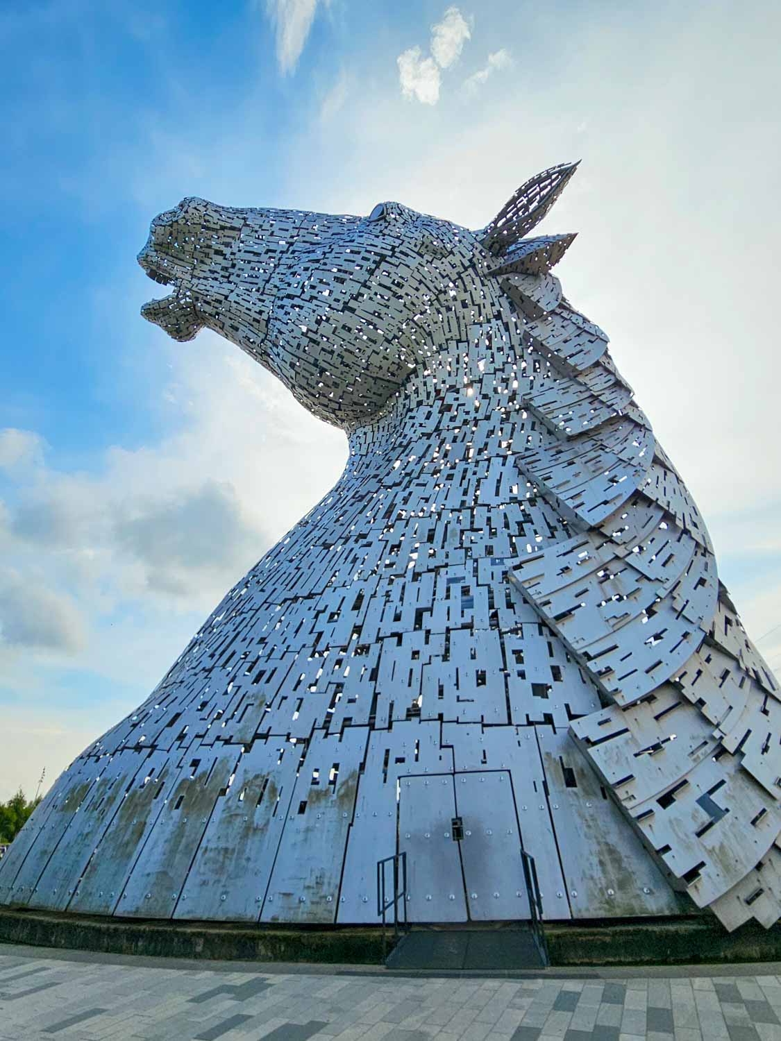 Side view of one of the horse head sculptures known as the Kelpies - a visit is one of the best things to do in Falkirk with kids