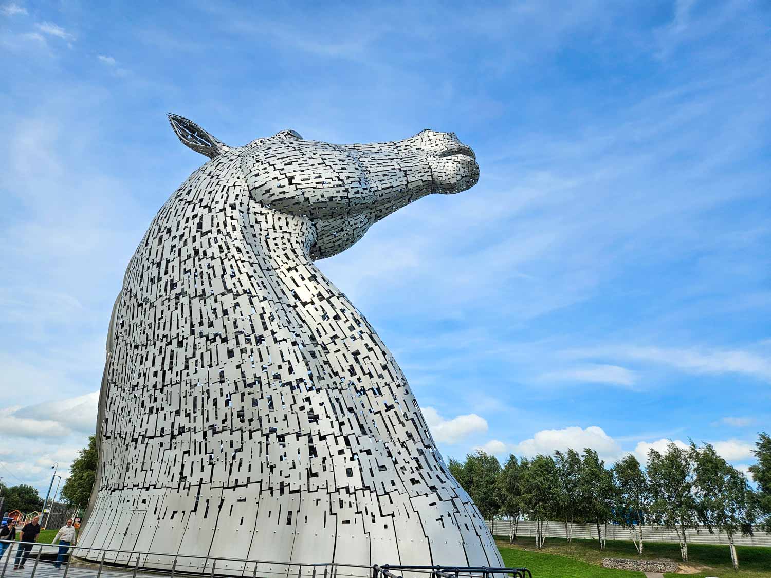 Side view of one of the horse head sculptures known as the Kelpies - a visit is one of the best things to do in Falkirk with kids