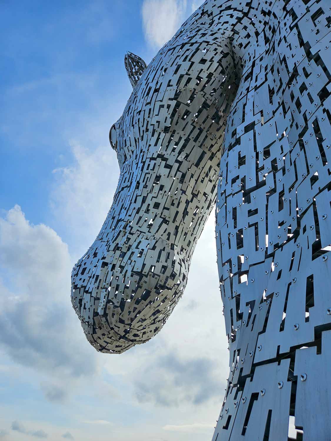 View of one of the horse head sculptures known as the Kelpies - a visit is one of the best things to do in Falkirk with kids