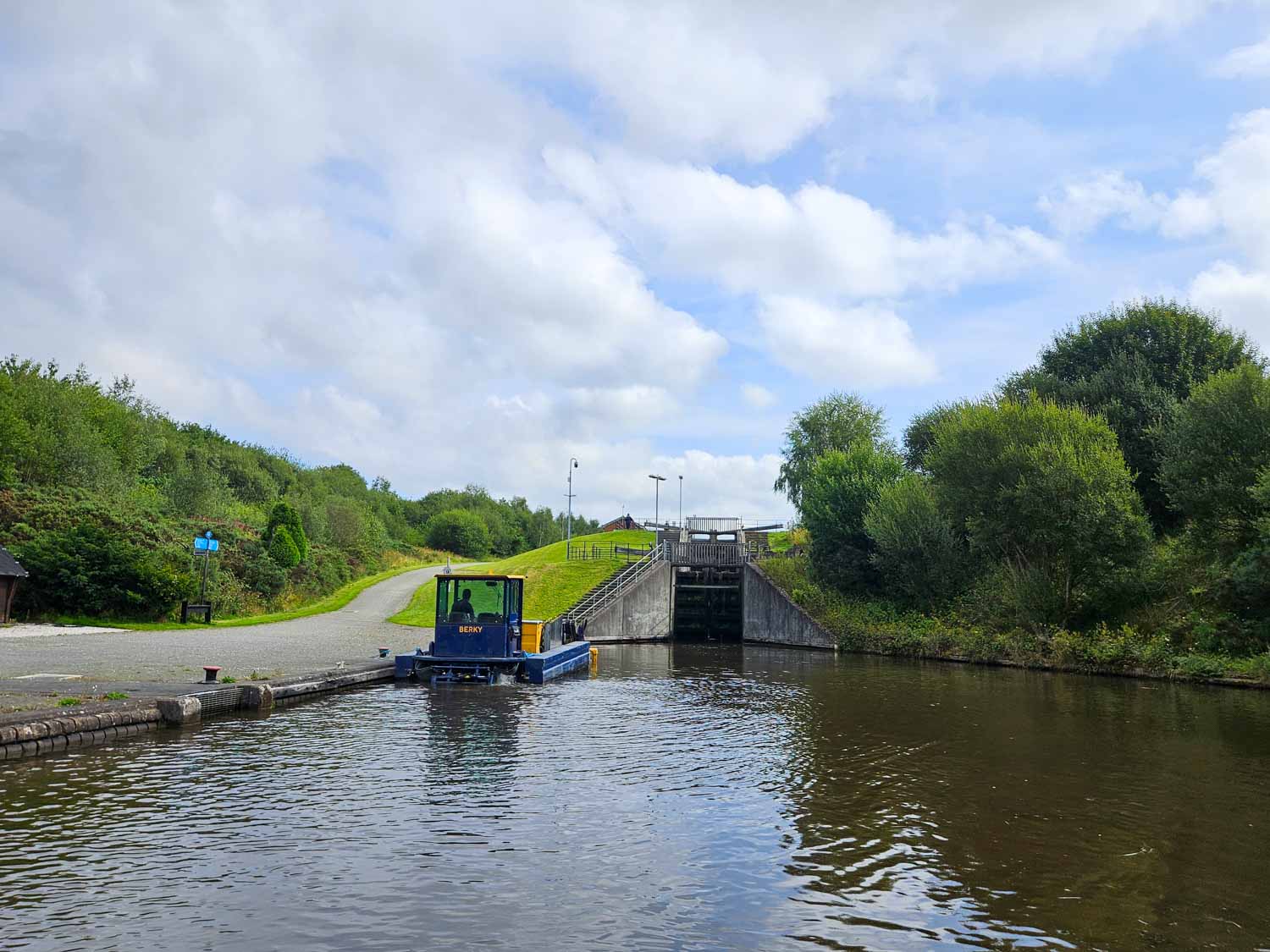 Path leading along the canalside and view of the Falkirk tunnel on a Falkirk Wheel boat tour - my pick of the best things to do in Falkirk with kids