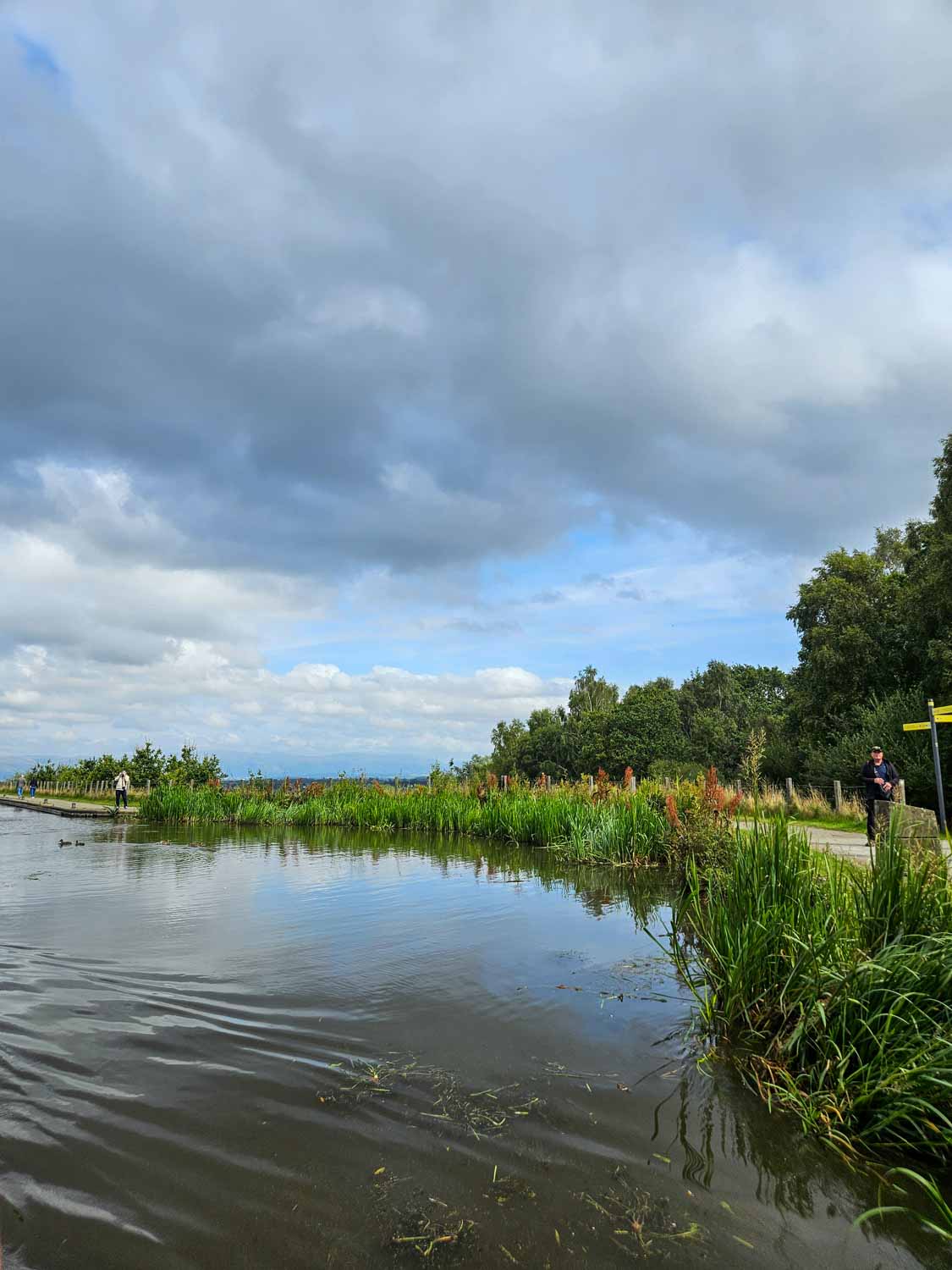 Walker on a path alongside the canal near the Falkirk Wheel - walking and cycling is a great way to explore Falkirk with kids