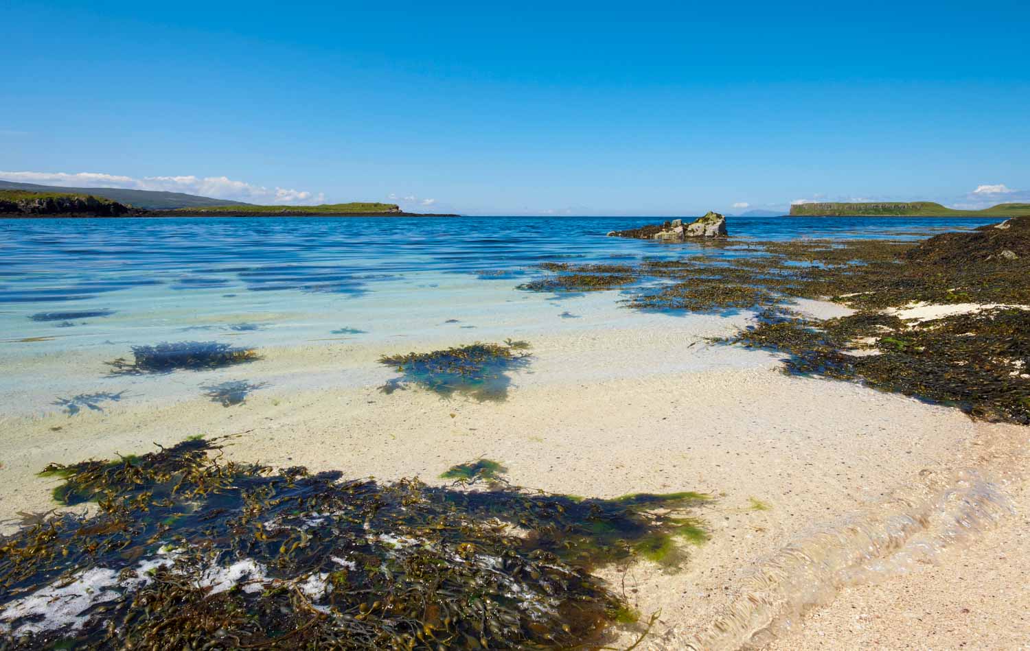 View across Coral Beach on the Isle of Skye with its pale pinkish beach and turquoise water - a visit is one of the best things to do in the Isle of Skye with kids