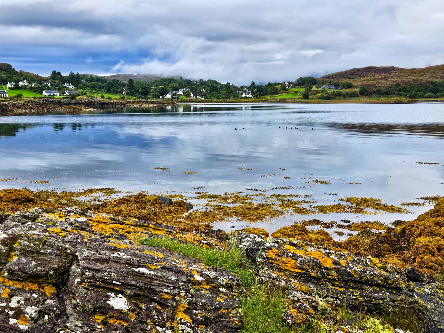 View across a loch at Isleornsay to slate-roofed white painted houses - my tips for the best things to do in the Isle of Skye with kids