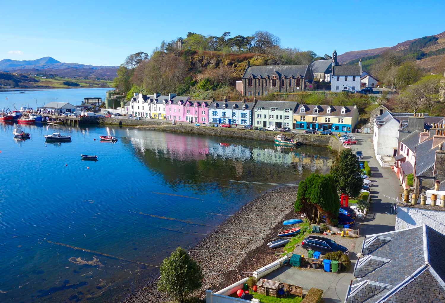 View of the colourful buildings and harbour at Portree - one of the best places to visit on the Isle of Skye with kids
