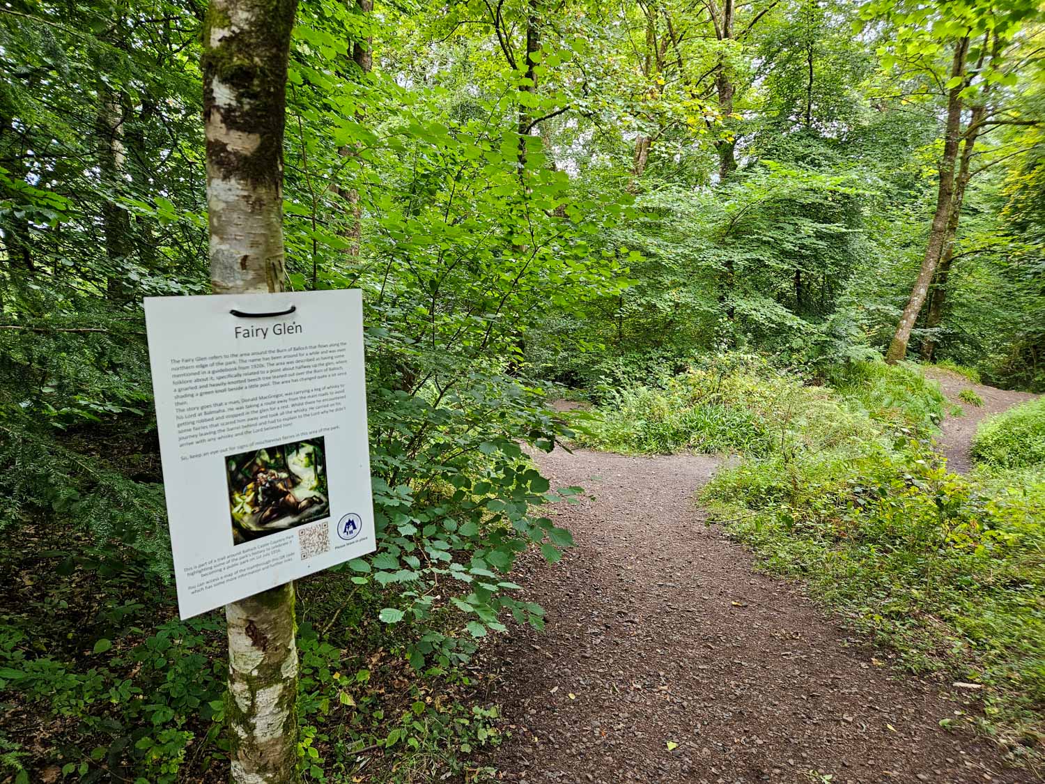 Sign reading fairy glen on a path through the woods at Balloch Castle Country Park - a visit is one of the best things to do in Loch Lomond with kids
