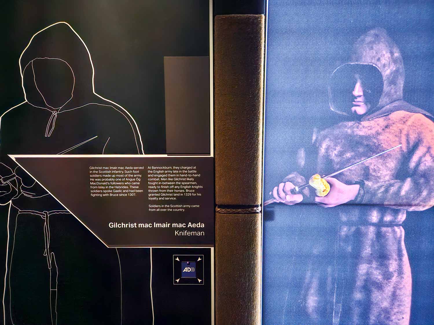 Picture of a man in hooded clothes with a knife, a description of one of the people at the battle of Bannockburn - the Bannockburn Experience is one of the best things to do in Stirling with kids