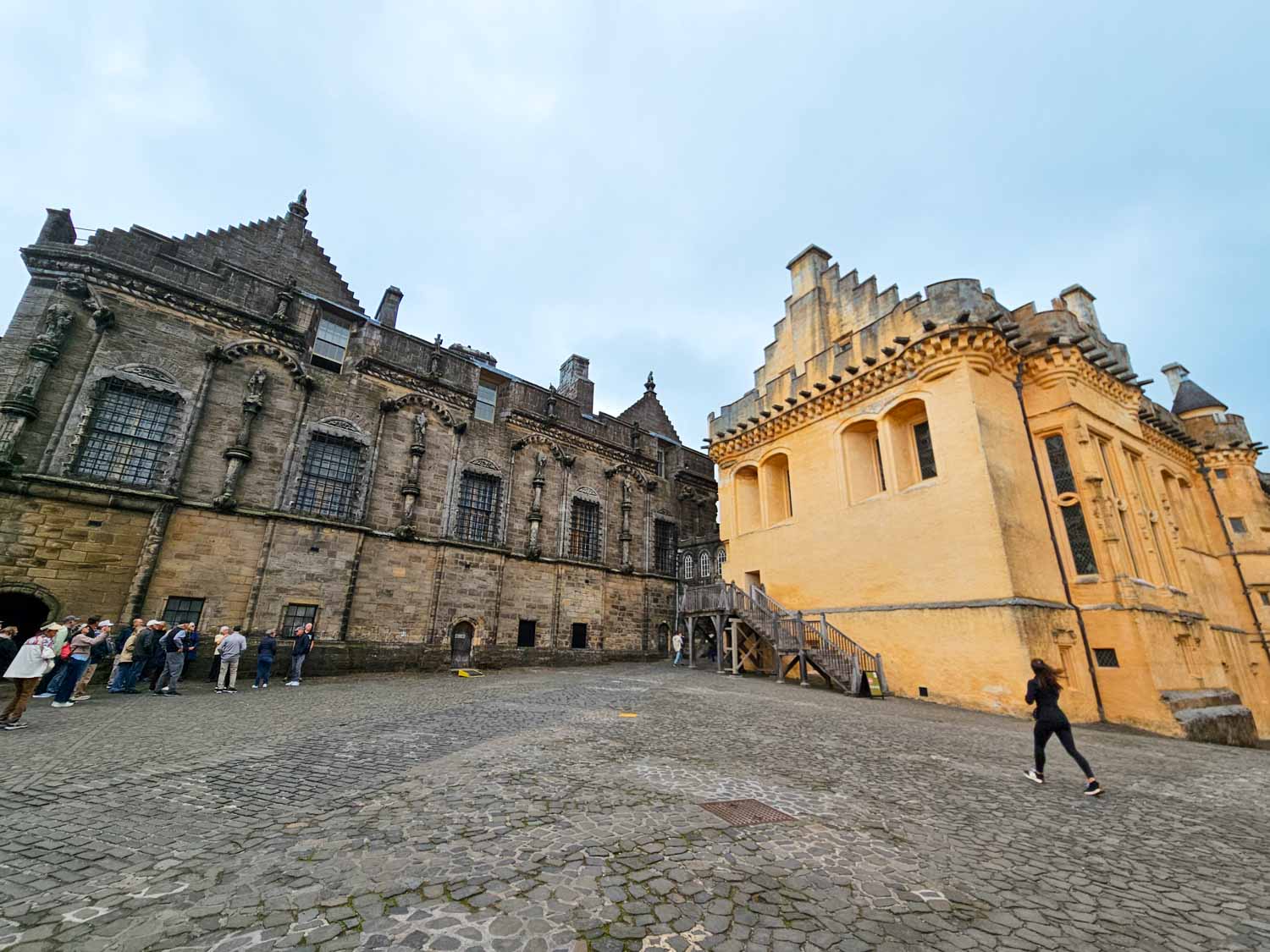 View across the cobbled courtyard to the Palace and back of the Great Hall at Stirling Castle - the city is an unmissable stop on a Scotland road trip with kids