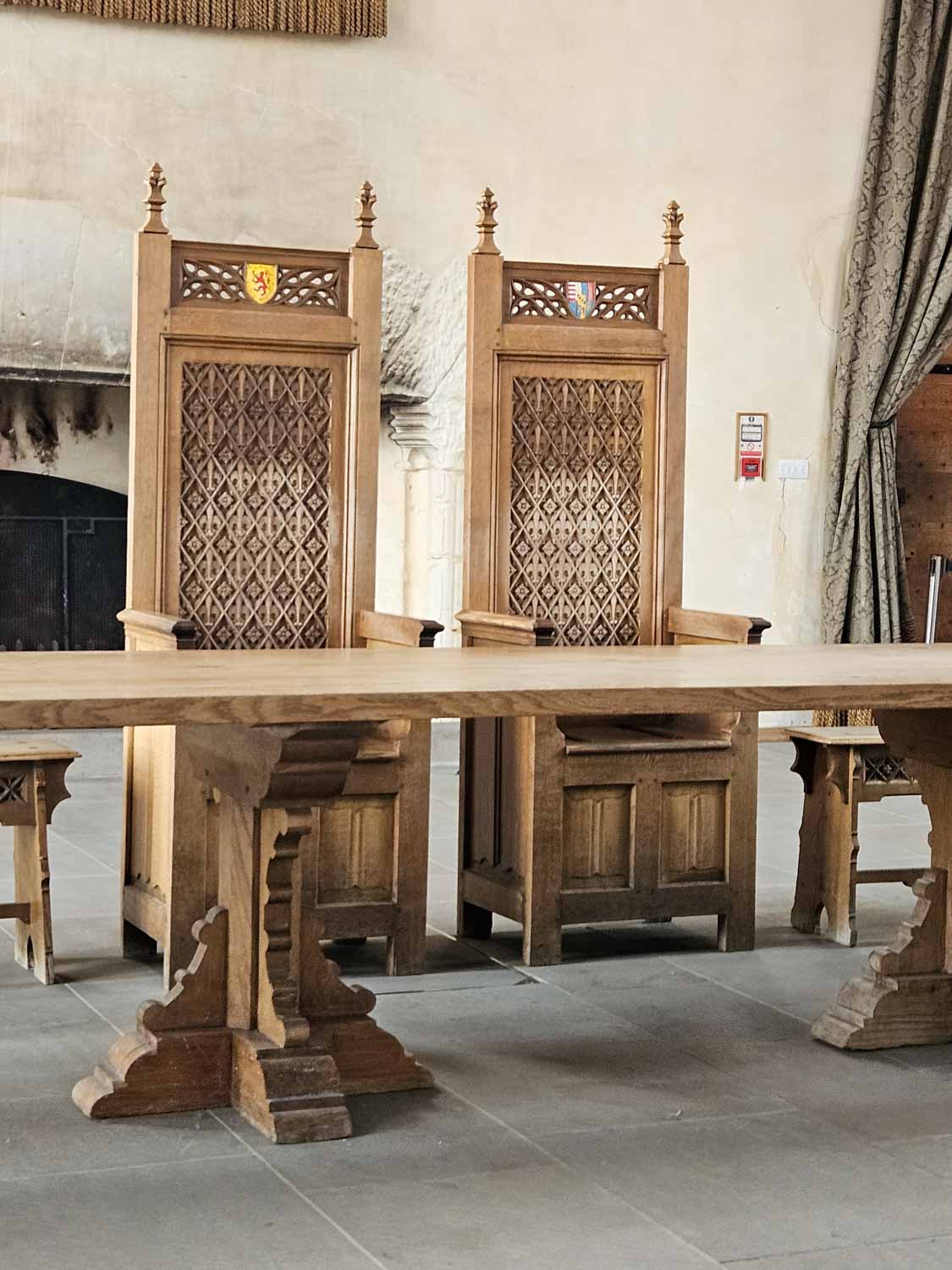 Two ornate wooden throne-like chairs in the Great Hall of Stirling Castle - a visit is one of the best things to do in Stirling with kids